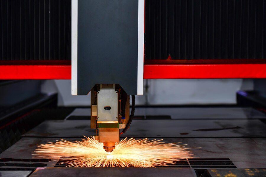 raytools-laser-cut-head-machine-while-cutting-sheet-metal-with-sparking-light-factory_67340-691